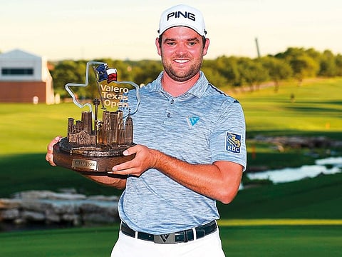 Corey Conners of Canada poses with the trophy after winning the 2019 Valero Texas Open at TPC San Antonio Oaks Course on Sunday.
