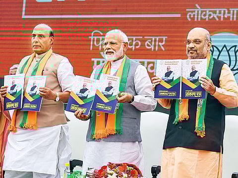 Modi, BJP president Amit Shah and Home Minister Rajnath Singh release the party’s manifesto in New Delhi on Monday.