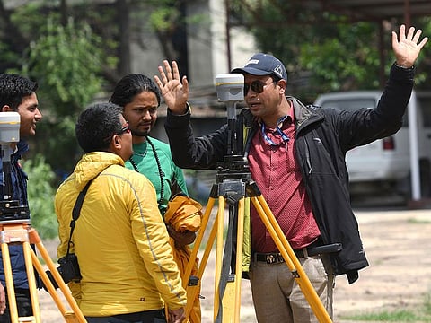 Nepali survey chief Khim Lal Gautam (R) along with his team, Suraj Sing Bhandari (2R), Yubaraj Dhital (L) and Mountain Guide Tshiring Janbu Sherpa (2L) check the equipments before leaving on an expedition to remeasure the height of Mount Everest in Kathmandu on April 8, 2019.