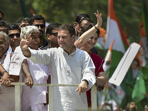 Congress President Rahul Gandhi along with party General Secretary and Uttar Pradesh - East in charge Priyanka Gandhi Vadra and other leaders wave at party supporters during a roadshow ahead of the former's nomination filing, ahead of the Lok Sabha elections, in Wayanad, Thursday, April 4, 2019.