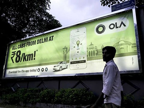 A billboard for Indian ride-hailing app OL.
