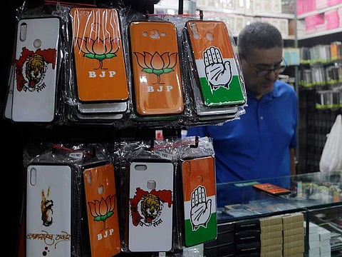 Mobile phone covers showing various political parties symbol are displayed at a wholesale shop in Mumbai, India.