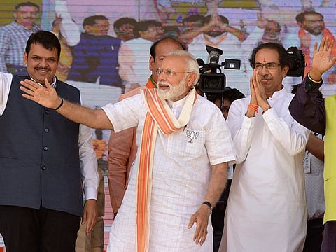 Prime Minister Narendra Modi, Shiv Sena chief Uddhav Thackeray and Maharashtra CM Devendra Fadanvis (L) at an election campaign rally in support of alliance candidates at Ausa in Latur district, Maharashtra, Tuesday, April 9, 2019.