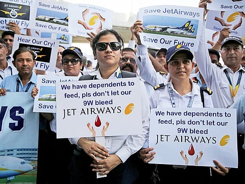 Employees of Jet Airways hold placards as they march during a protest outside Indira Gandhi International Airport in New Delhi, on Saturday.