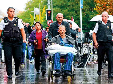 Temel Atacocugu (C), a survivor of the March 15 twin mosque massacre, leaves the Christchurch District Court on April 5, 2019 after alleged gunman Brenton Tarrant, accused of shooting dead 50 Muslims during the March 15 attack on two mosques, appeared for his hearing via audio-visual link from a maximum-security prison in Auckland.