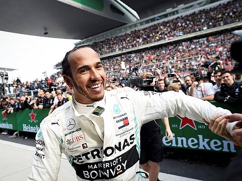 Mercedes' British driver Lewis Hamilton celebrates after winning the Formula One Chinese Grand Prix in Shanghai on April 14, 2019.