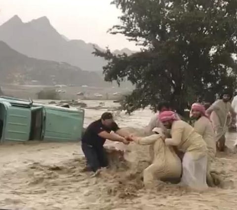 People help a man swept away by flash floods in RAK. Residents woke up to a heavy downpour on Sunday in the northern emirates. Several schools were also reported to have shut down for the day due to bad weather.