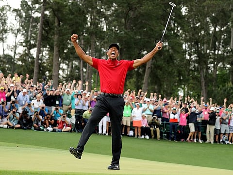Tiger Woods celebrates on the 18th hole after winning the 2019 Masters.