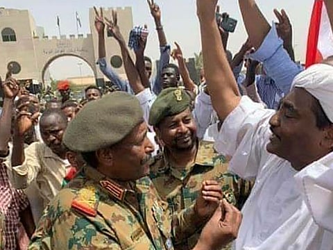 Lieutenant General Abdel Fattah Al Burhan, the new chief of the military council taking over in Sudan following the ouster of president Omar Al Bashir, speaking with demonstrators outside the army headquarters in the capital Khartoum.