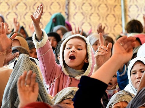 A young Pakistani mourner of the Shia Hazara ethnic minority shouts slogans as she sits-in during a protest in Quetta on April 15, 2019, against the suicide blast at a fruit market. At least 20 people were killed and 48 wounded on April 12 by a powerful suicide blast apparently targeting the Shia Hazara ethnic minority at a crowded fruit market in Pakistan's Quetta city, officials said.