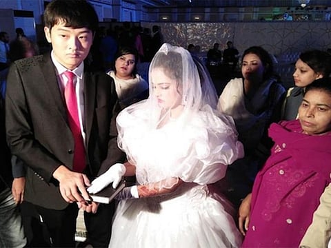 Mehak Perwaiz takes her wedding vows with Song Guoqing at a marriage hall in Lahore in 2018