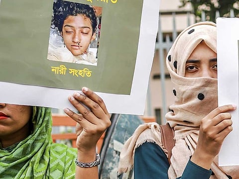 In this photo, Bangladeshi women hold placards and photographs of schoolgirl Nusrat Jahan Rafi at a protest in Dhaka, following her murder by being set on fire after she had reported a sexual assault.