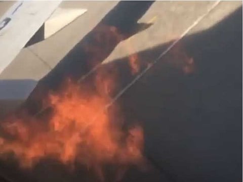 After they spotted flames coming out of one of the plane’s engines, some passengers — two mean and a woman seated in the emergency exit row — reportedly opened the emergency exitand climbed out onto the wing.
