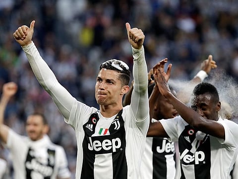 Juventus' Cristiano Ronaldo celebrates with his teammates at the end of the Serie A soccer match between Juventus and AC Fiorentina, at the Allianz stadium in Turin, on Saturday.