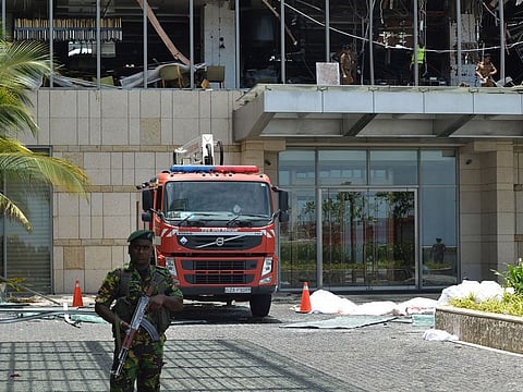 Sri Lankan security personnel stand guard at entrance to the luxury Shangri-La Hotel in Colombo on April 21, 2019 following an explosion.