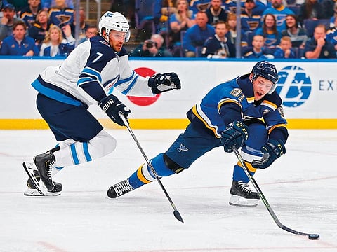 Vladimir Tarasenko #91 of the St. Louis Blues looses control of the puck against Ben Chiarot #7 of the Winnipeg Jets in Game Six of the Western Conference First Round during the 2019 NHL Stanley Cup Playoffs at the Enterprise Center on April 20, 2019 in St. Louis, Missouri.