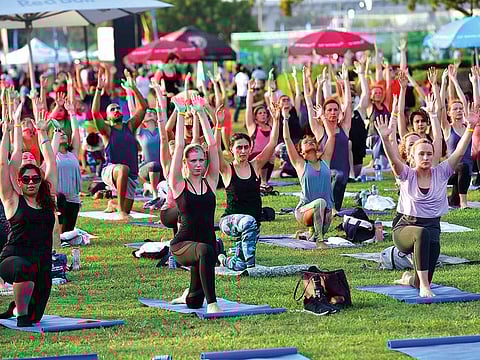 Residents doing yoga at a weekend carnival in Dubai. The rising popularity of yoga has prompted a two-day Arab Region Instructors Conference in the city on April 26-27.