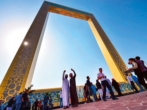 Tourists at the base of the iconic Dubai Frame.