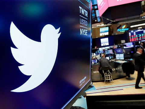 The logo for Twitter is displayed above a trading post on the floor of the New York Stock Exchange.
