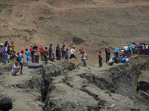 Local people look on in a jade mine where the mud dam collapsed in Hpakant, Kachin state, Myanmar April 23, 2019.