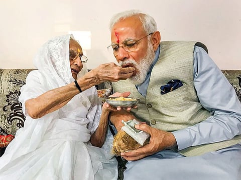 Prime Minister Narendra Modi is offered sweets by his mother Hiraba as he meets her after casting his vote, during the third phase of the 2019 Lok Sabha elections, in Gandhinagar, Tuesday, April 23, 2019.