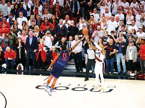 Portland Trail Blazers guard Damian Lillard (0) makes a three-point shot over Oklahoma City Thunder forward Paul George (13) to defeat Oklahoma City Thunder 118-115 in game five of the first round of the 2019 NBA Playoffs at Moda Center.