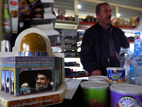 a piggy bank with a photo of Hezbollah leader, Sayyed Hassan Nasrallah, is displayed to collect money for the militant group, in the southern Lebanese village of Kfar Rumman, Lebanon.
