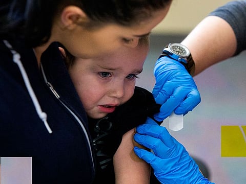 Alisa Johnson holds her son, Jonny Stone, 2, as he gets the measles, mumps and rubella shot in Portland, Oregon, Feb. 16, 2019.