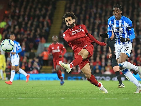 Liverpool's Mohammad Salah shoots on goal during the English Premier League match against Huddersfield Town at Anfield Stadium, in Liverpool, on Friday.