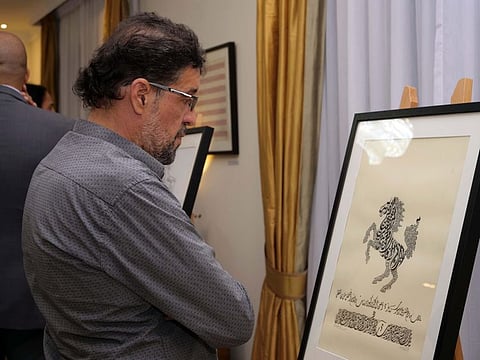 A visitor looks at one of the calligraphy work on display at the exhibition.