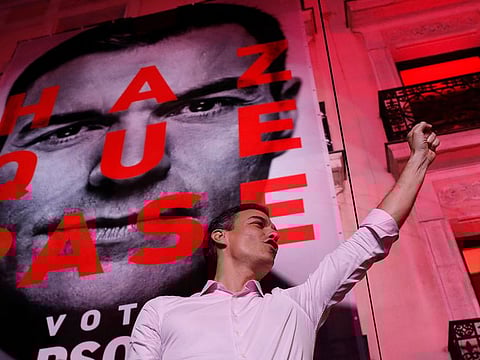 Spain's Prime Minister and Socialist Party leader Pedro Sanchez gestures to supporters.