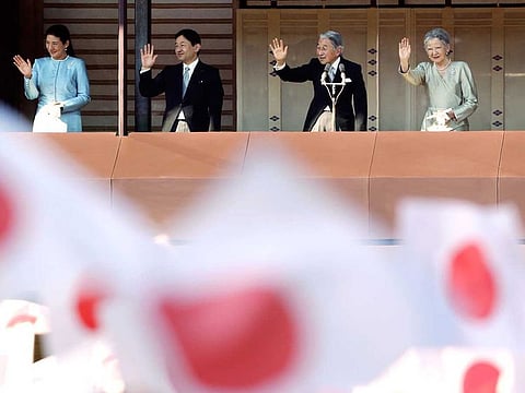 Japan's Crown Prince Naruhito, second from left, and Crown Princess Masako, left, Japan's Emperor Akihito, and Empress Michiko wave to well-wishers from a balcony during a New Year's public appearance at Imperial Palace in Tokyo in Jan 2014.
