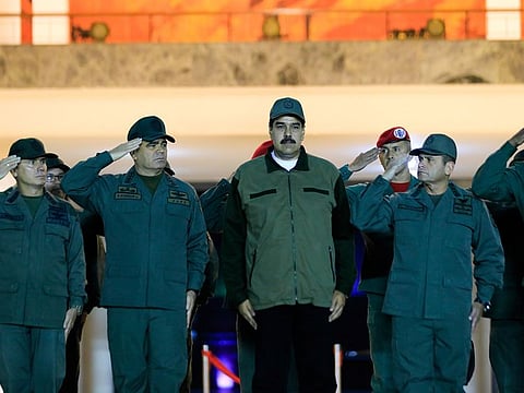Venezuela's President Nicolas Maduro stands next to Venezuela's Defense Minister Vladimir Padrino Lopez and Remigio Ceballos, Strategic Operational Commander of the Bolivarian National Armed Forces, during a ceremony at a military base in Caracas, Venezuela.
