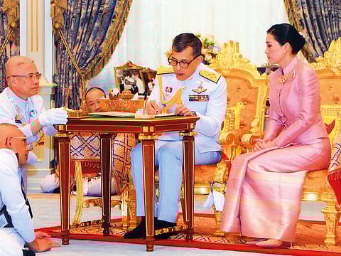 This handout picture taken and released by Thai Royal Household Bureau on May 1, 2019 shows King Maha Vajiralongkorn (C) and Queen Suthida during their wedding ceremony in Bangkok.
