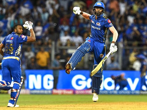 Mumbai Indians cricketer Hardik Pandya (L) and his teammate Kieron Pollard celebrate after winning the 2019 Indian Premier League (IPL) Twenty20 cricket match between Mumbai Indians and Sunrisers Hyderabad at the  Wankhede Stadium in Mumbai on May 2, 2019