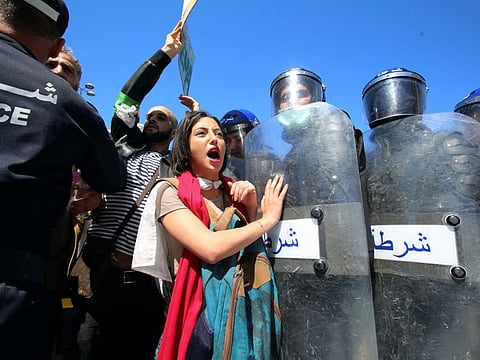 Police officers prevent demonstrators from marching during a May Day protest on Labour Day in Algiers, Algeria.