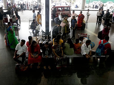 Stranded passengers wait outside the Netaji Subhas Chandra Bose international airport after all flights were suspended following cyclone Fani landfall in eastern coast, in Kolkata, India