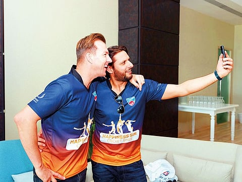 Shahid Afridi and Brett Lee click a selfie during the Happiness Sim Cricket Sixes at Abu Dhabi CC at Zayed Cricket Stadium.
