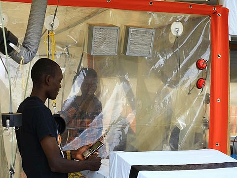 File photo: Kasereka Mulanda, 24, talks with his wife who is suffering from the Ebola virus in an isolation area in Beni, Eastern Congo.