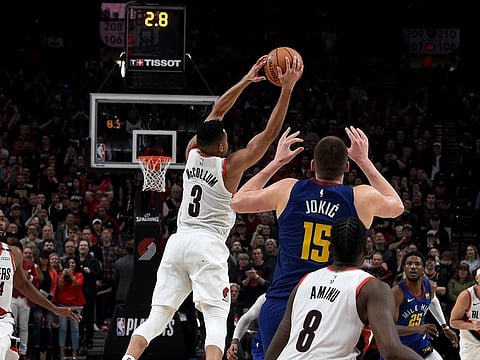 CJ McCollum #3 of the Portland Trail Blazers intercepts a pass intended for Nikola Jokic #15 of the Denver Nuggets during the fourth overtime of game three of the Western Conference Semifinals at Moda Center on May 03, 2019 in Portland, Oregon.