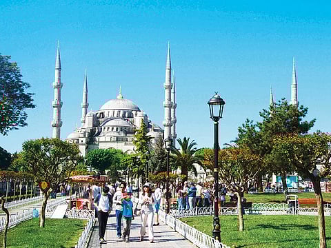 Tourists at the Blue Mosque in Istanbul.