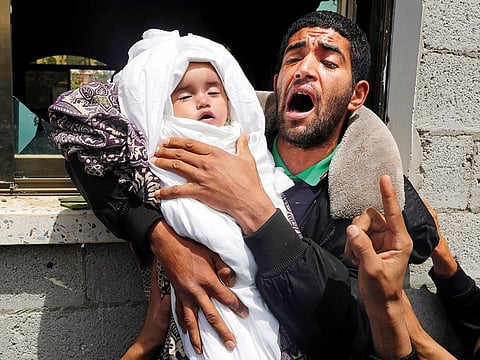 A relative of 14-month old Palestinian baby Seba Abu Arar carries her body during her funeral in Gaza City May 5, 2019.