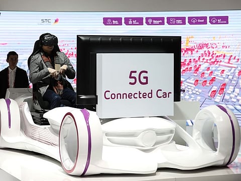 File photo: An attendee wears a virtual reality (VR) headset for a 5G connected car experience on the Saudi Telecom stand during the opening day of the Mobile World Congress (MWC) in Barcelona, Spain, on February 26, 2018.
