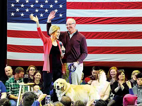 In this file photo taken on January 12, 2019 Senator Elizabeth Warren (D-MA), husband Bruce Mann and their dog Bailey take the stage before Warren addresses an “Organizing Event” as part of her exploratory presidential committee at Manchester Community College in Manchester, NH.