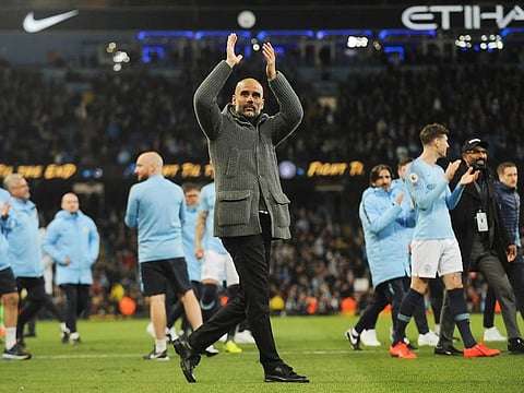 Manchester City manager Pep Guardiola greets supporters at the end of the English Premier League soccer match between Manchester City and Leicester City at the Etihad stadium in Manchester, England, on Monday, May 6, 2019.