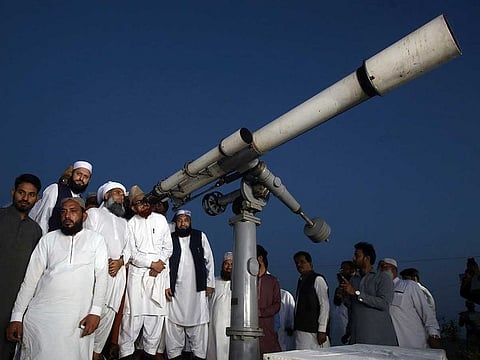 Clerics of Pakistan's Moon Sighting Committee use a telescope for the new moon that signals the start of Islamic month Ramadan, in Karachi on May 5.