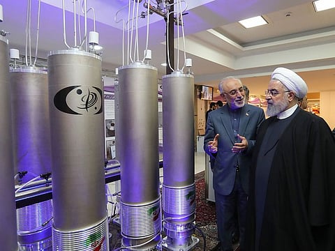 Iranian presidential office, Iranian President Hassan Rouhani (2nd L) listens to head of Iran's nuclear technology organisation Ali Akbar Salehi (R) during the "nuclear technology day" in Tehran. Iran will no longer respect limits it agreed on its enriched uranium and heavy water stocks under a 2015 nuclear deal with major powers, officials said on May 8, 2019