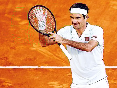 Switzerland's Roger Federer celebrates after winning a ATP Madrid Open round of 64 tennis match against France's Richard Gasquet at the Caja Magica in Madrid on May 7, 2019.