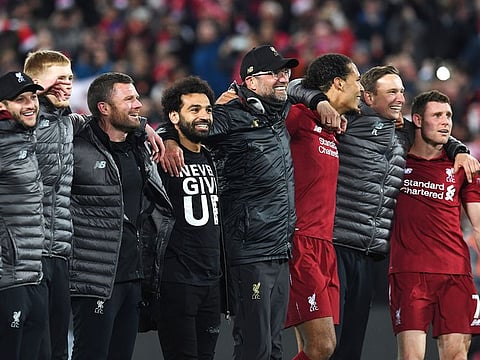 Liverpool's Mohamed Salah (4L), manager Jurgen Klopp (C) and Virgil van Dijk celebrate after winning the UEFA Champions league semi-final second leg football match between Liverpool and Barcelona at Anfield in Liverpool, north west England on May 7, 2019.