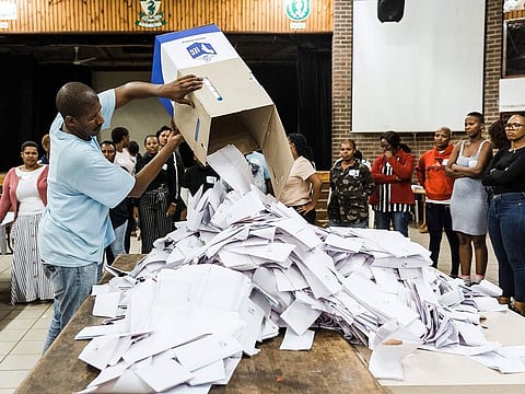 An Independent Electoral Officer (IEC) opens a ballot box as counting begins at the Addington Primary School after voting ended at the sixth national general elections in Durban.